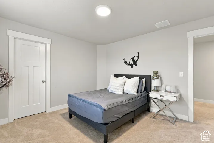 Plush carpet flooring, white trim, recessed ceiling light, paneled interior door, and light-toned wall paint