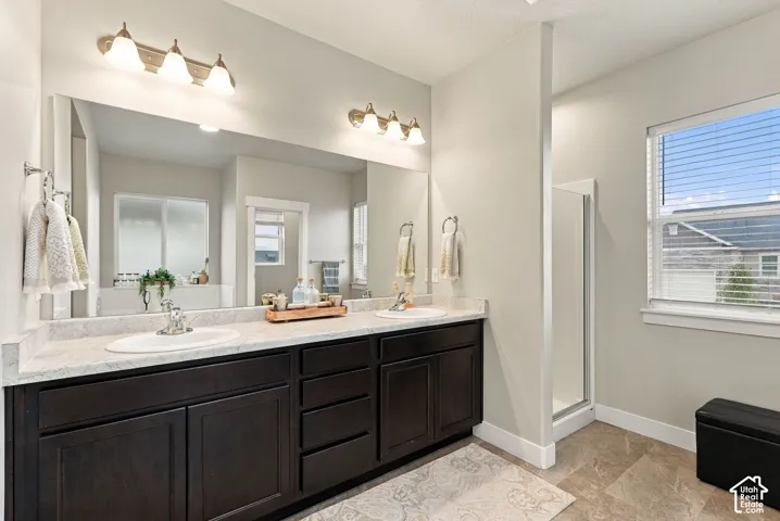 Dual vanity with dark wood-finish cabinetry and light-toned countertops