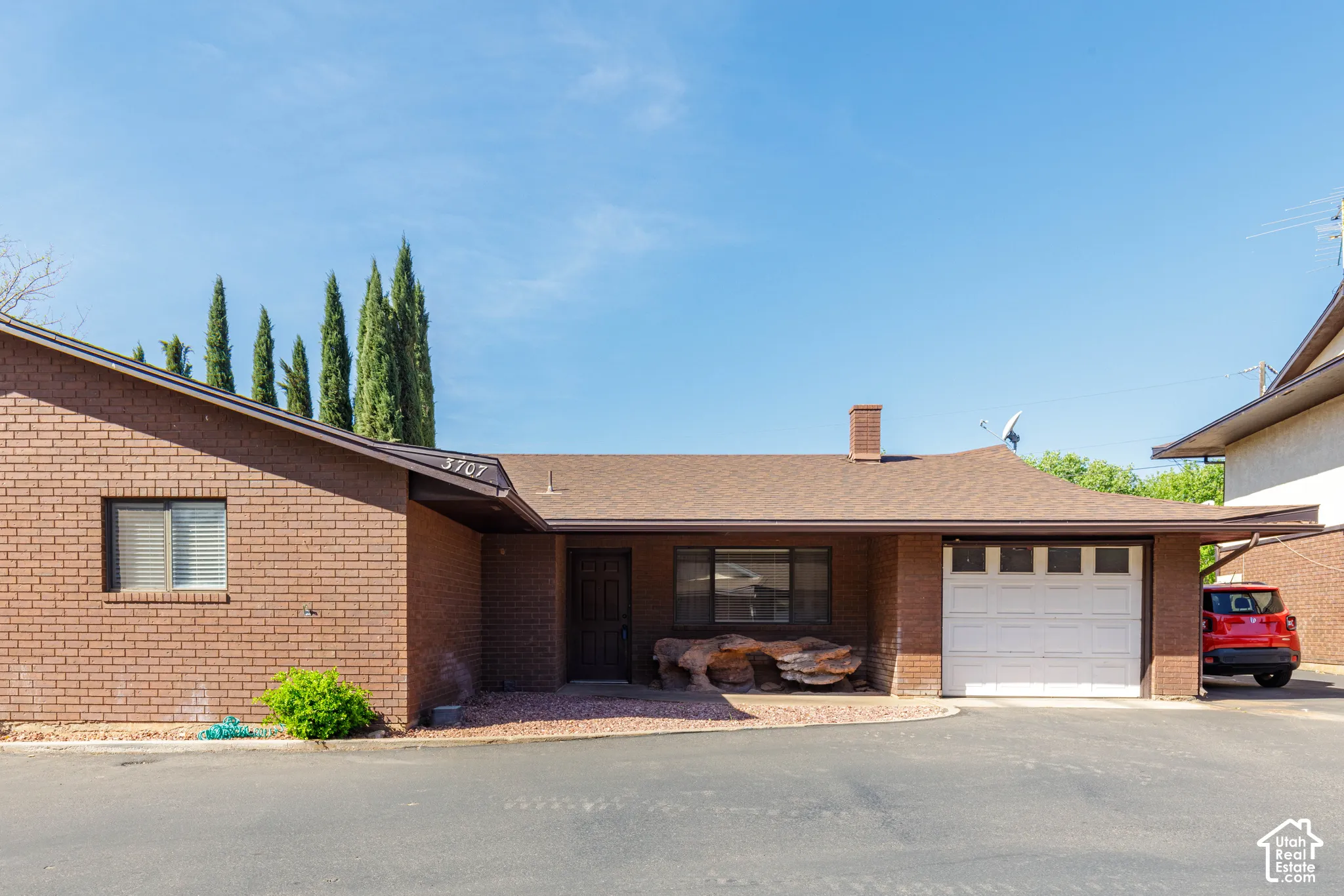 Brick exterior with a brown shingle roof