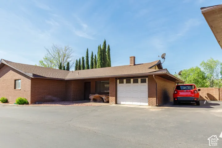 Brick exterior with a brown shingle roof