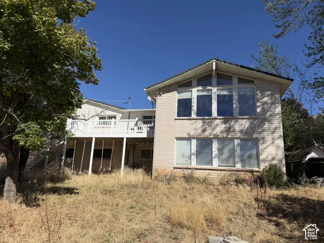 Two-story light brick exterior with a prominent A-frame window design