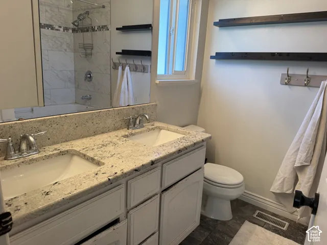 Dual vanity with light-toned countertop, integrated sinks, and chrome faucets