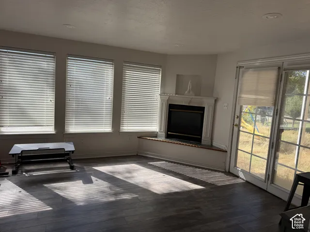 Recessed lighting, bay window, wood-finish flooring, built-in fireplace, and French doors