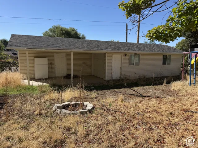 Exterior structure with horizontal siding and an asphalt shingle roof