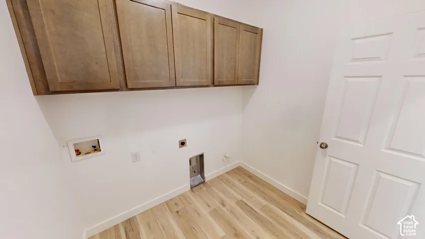 Wood-finish flooring, white walls, and built-in upper cabinetry