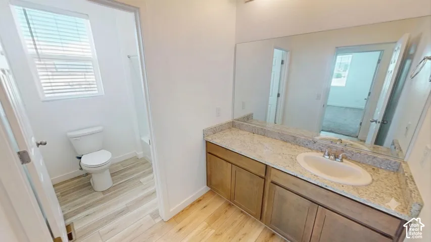Double vanity with light-toned cabinetry, an integrated sink, and a large wall-mounted mirror