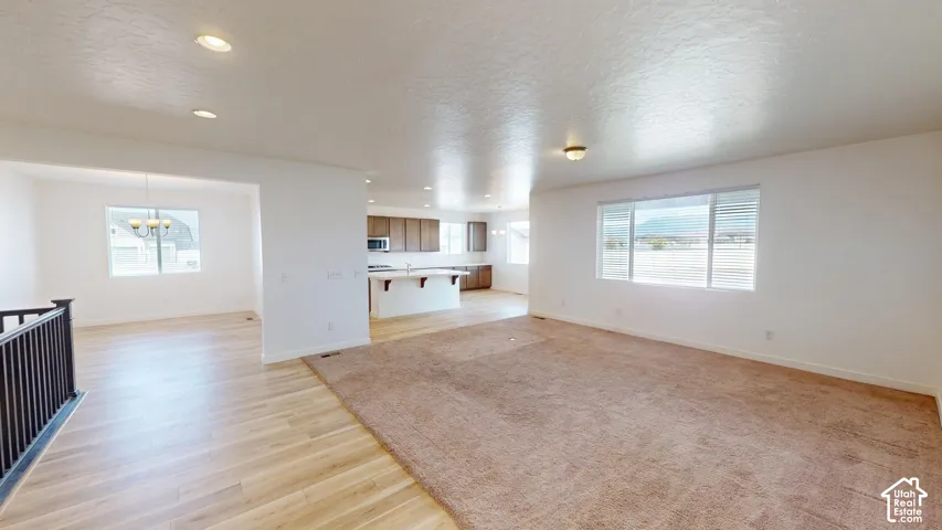 Spacious living area with carpeting and recessed lighting
