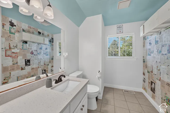 Vanity with a light-toned countertop, undermount sink, and dark-finish faucet
