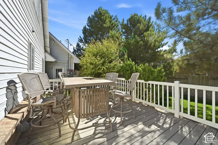 Expansive outdoor deck with wood-finish flooring and white railing