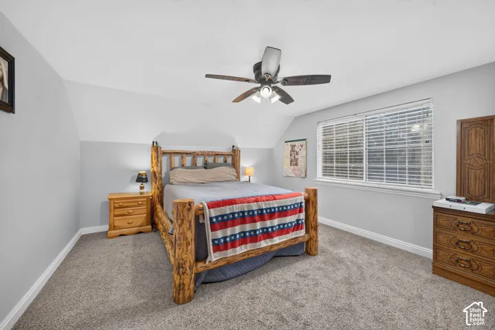Recessed lighting, ceiling fan with integrated lighting, carpet flooring, and a window with blinds