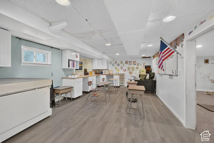 Recessed lighting throughout, drop ceiling, and wood-finish flooring