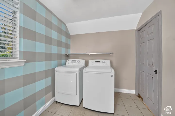 Tiled flooring, built-in shelving, and a window with blinds