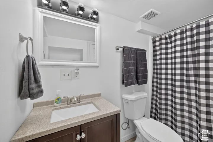 Vanity with a light-toned countertop, undermount sink, and brushed nickel faucet