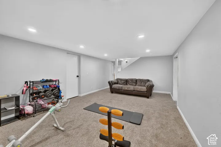 Recessed ceiling lighting, light gray walls, and carpeting throughout