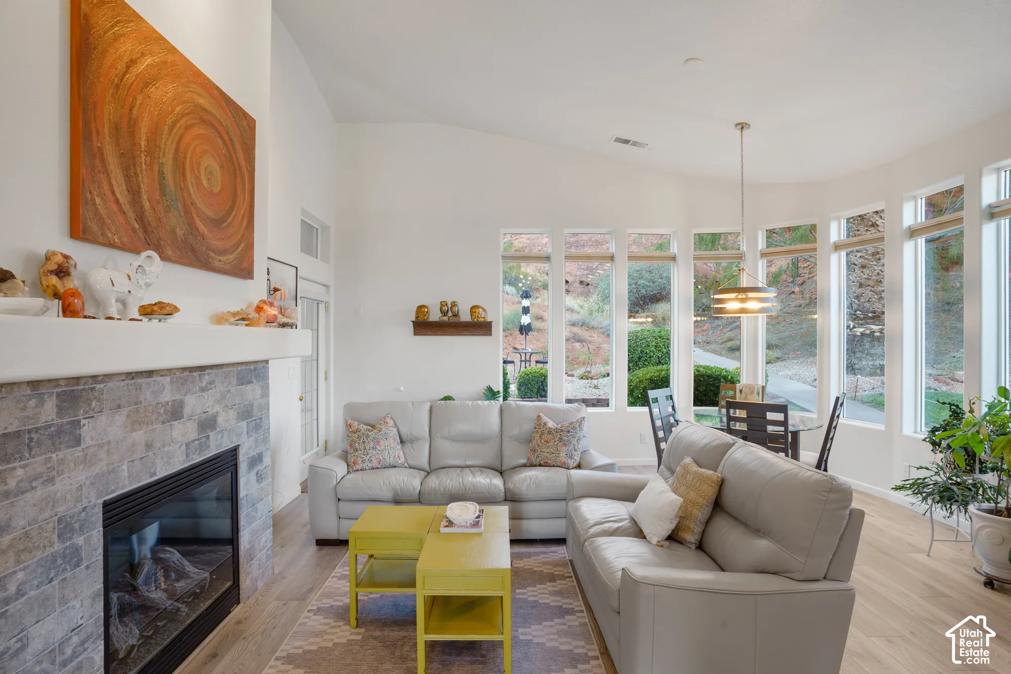 Vaulted ceilings, a stone-faced fireplace, and wood-finish flooring