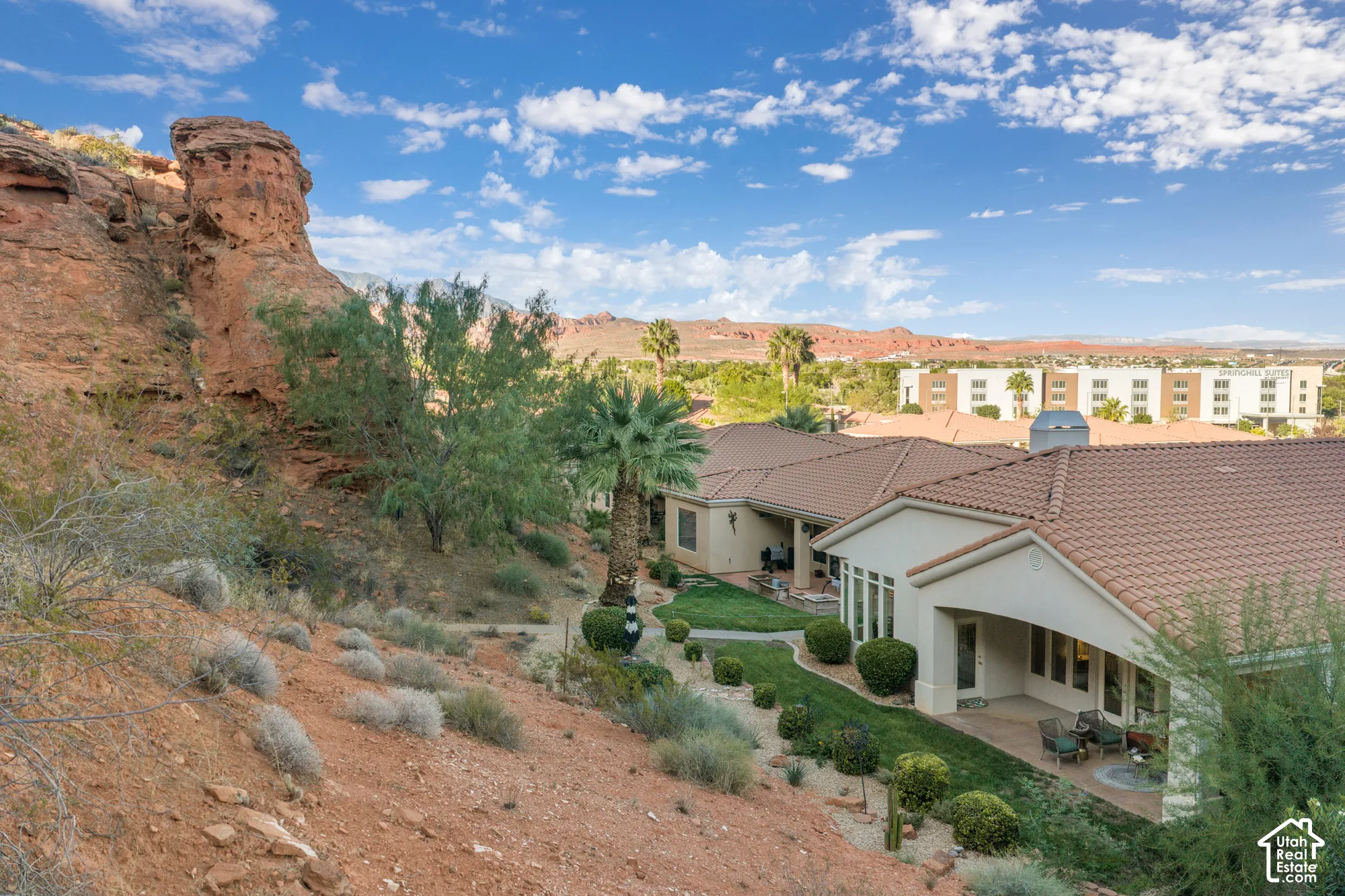 Terracotta tile roofing, desert landscaping, and a covered patio with outdoor seating