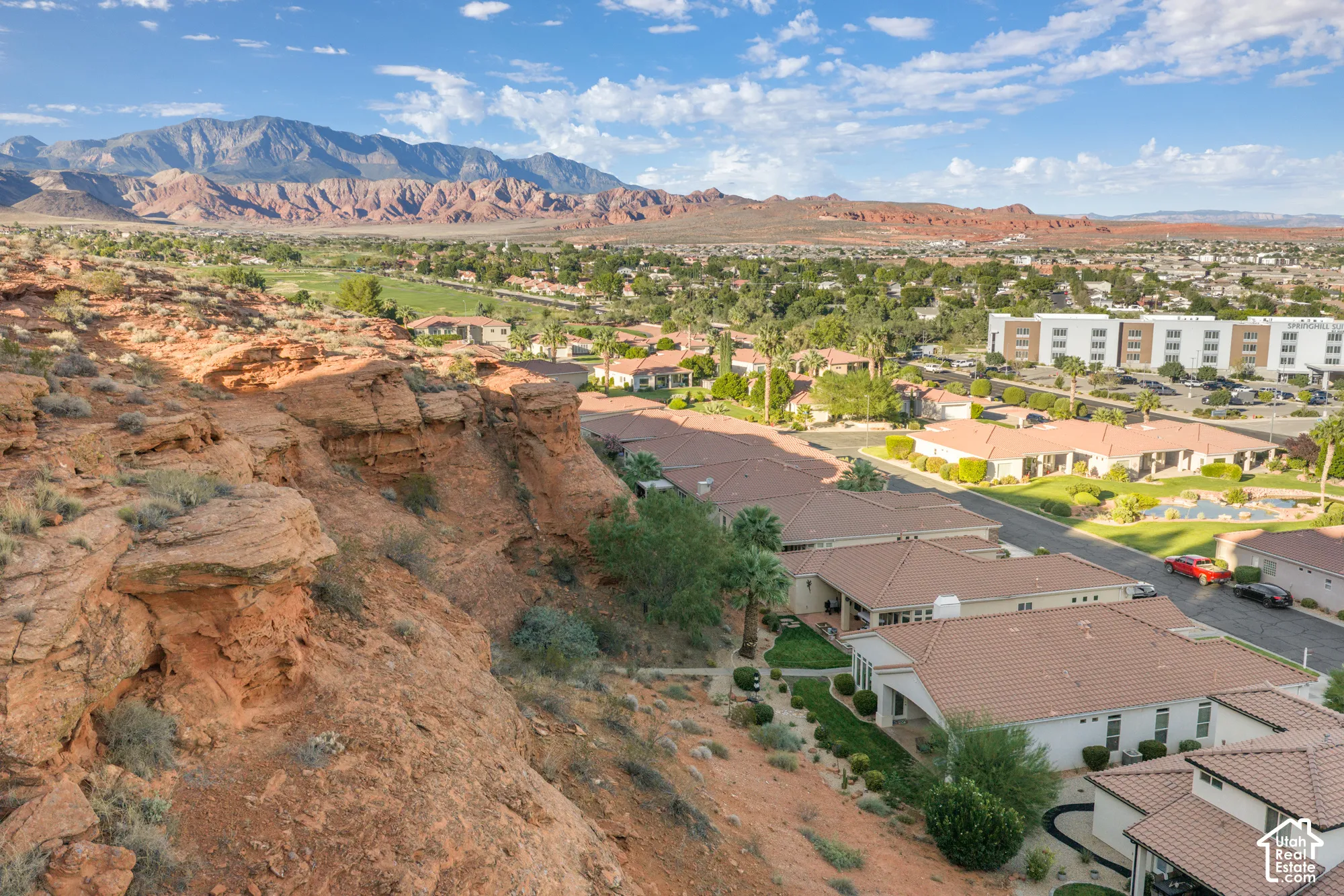 Red rock mountain backdrop with a townscape and golf course