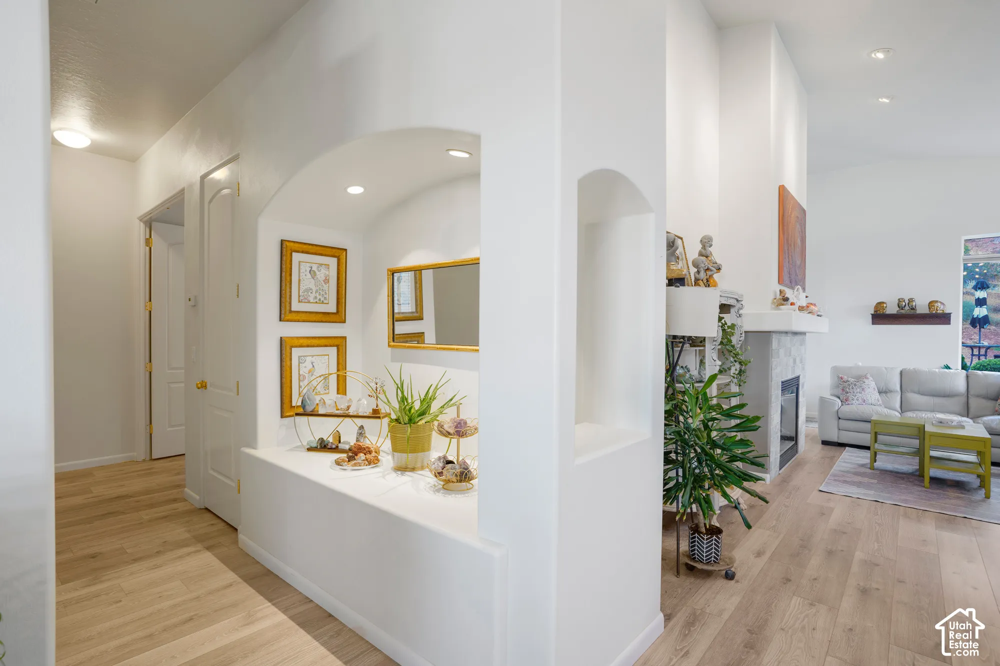 Arched entryway with recessed lighting and wood-finish flooring