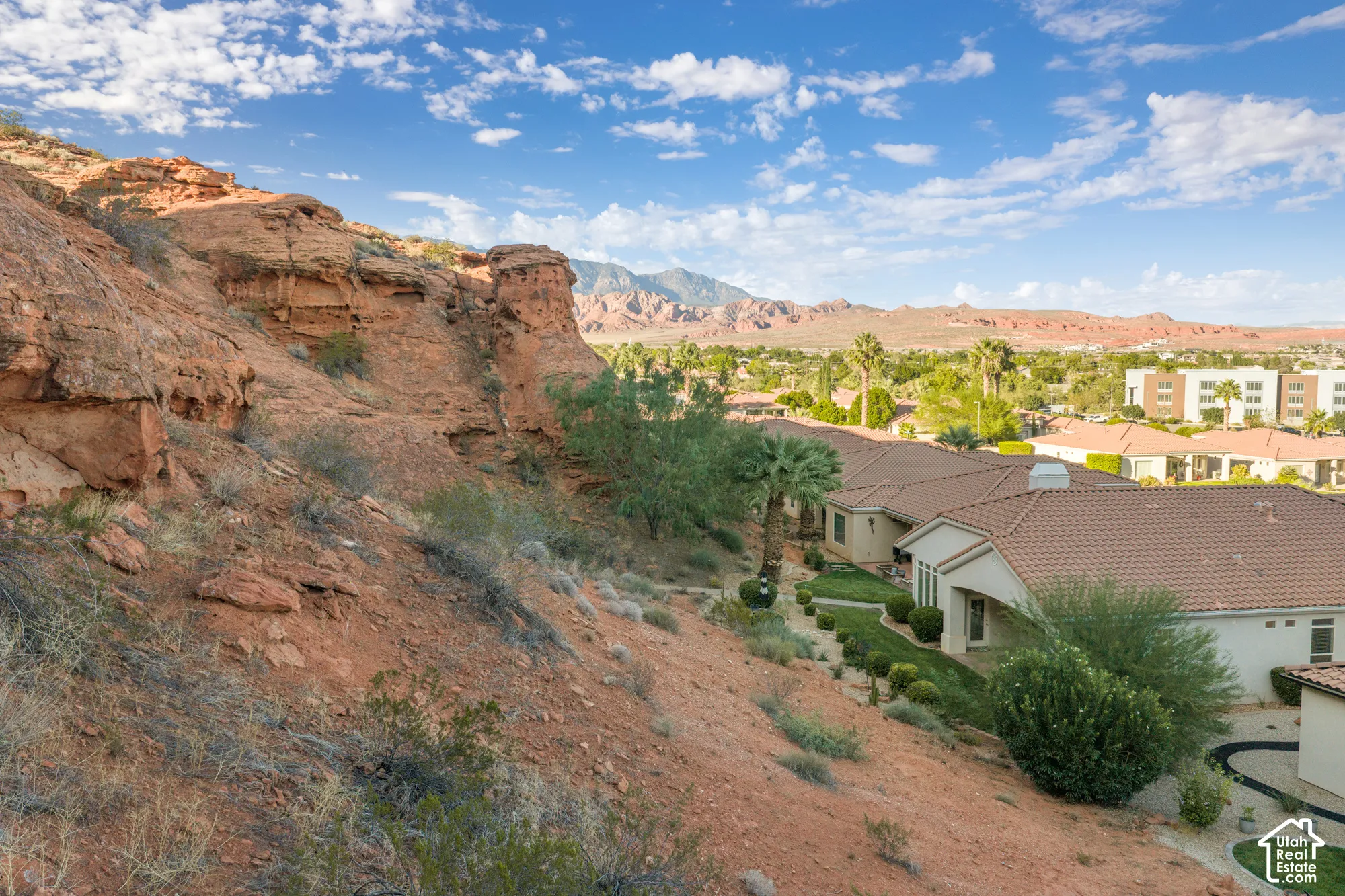 Terracotta tile roof, stucco exterior, and mature desert landscaping