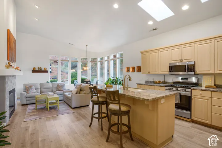 Spacious kitchen with wood-finish cabinetry, stainless steel appliances, and granite countertops