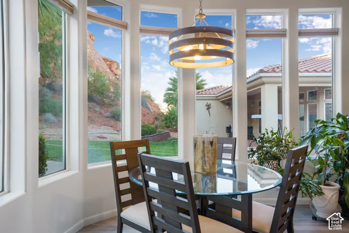 Bay window with multiple large picture windows, a decorative overhead light fixture, and tile roofing visible