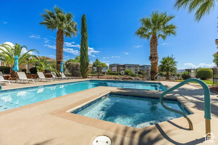Outdoor pool with an integrated spa, surrounded by a concrete deck