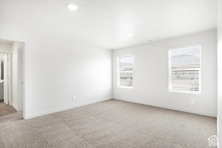 **DICSLAIMER** Interior package may vary.  Recessed lighting, neutral wall paint, two windows with blinds, and light-toned carpeting