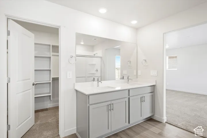 **DICSLAIMER** Interior package may vary.  Dual vanity with light gray cabinetry, white countertops, and chrome fixtures