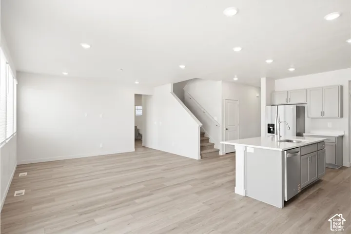**DICSLAIMER** Interior package may vary.  Open-concept living area with wood-finish flooring, recessed lighting, and large windows