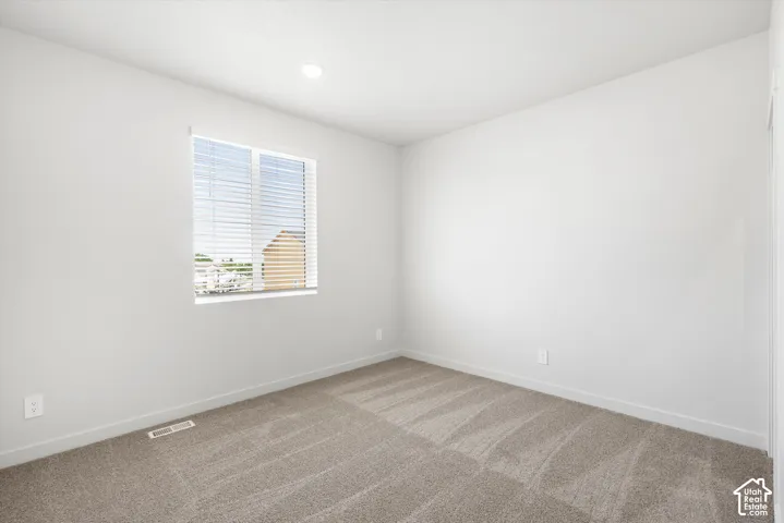 **DICSLAIMER** Interior package may vary.  Neutral-toned carpeting, white painted walls, and a recessed ceiling light