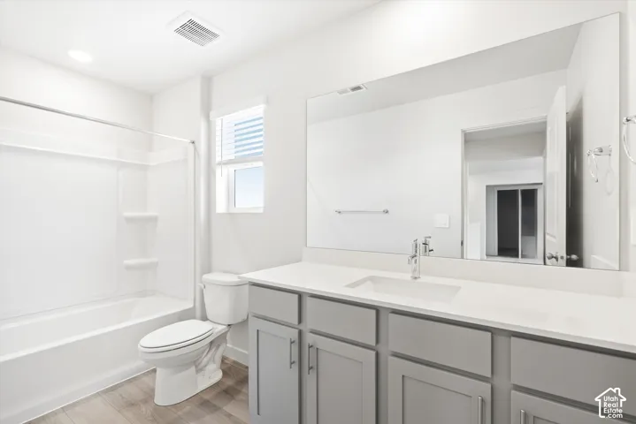 **DICSLAIMER** Interior package may vary.  White bathtub with shower, toilet, and wood-finish flooring