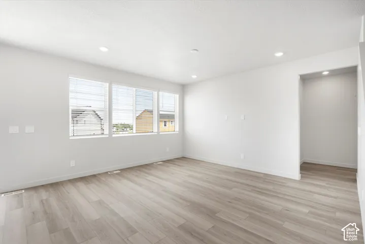 **DICSLAIMER** Interior package may vary.  Light wood-finish flooring, recessed lighting, and a wall of three windows with blinds