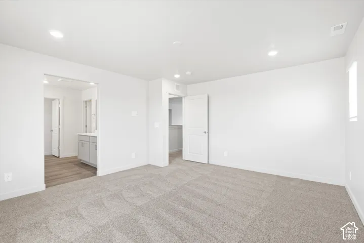 **DICSLAIMER** Interior package may vary.  Plush carpeted flooring, recessed lighting, white walls, and a window providing natural illumination