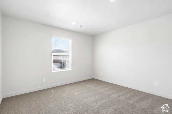 **DICSLAIMER** Interior package may vary.  Neutral-toned carpeting, white walls, recessed lighting, and a window with horizontal blinds