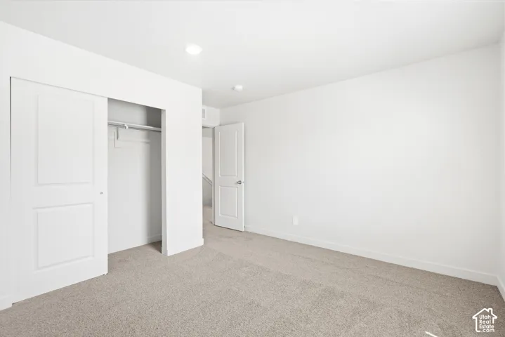 **DICSLAIMER** Interior package may vary.  Recessed lighting, light-toned carpeting, white walls, and a closet with sliding doors