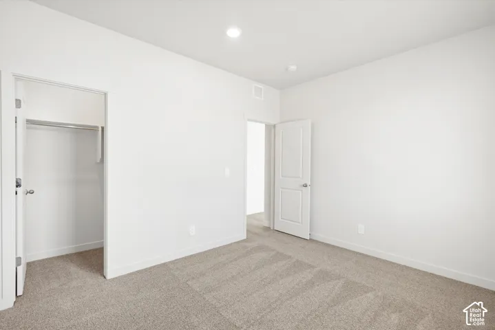 **DICSLAIMER** Interior package may vary.  Recessed lighting, white walls, gray carpeting, white interior doors, and a closet with a built-in rod