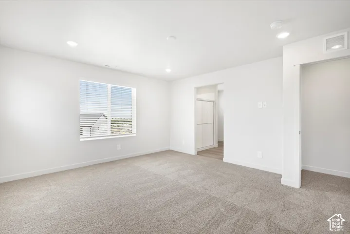 **DICSLAIMER** Interior package may vary.  Carpeted flooring, recessed lighting, window with blinds, white trim, and white walls