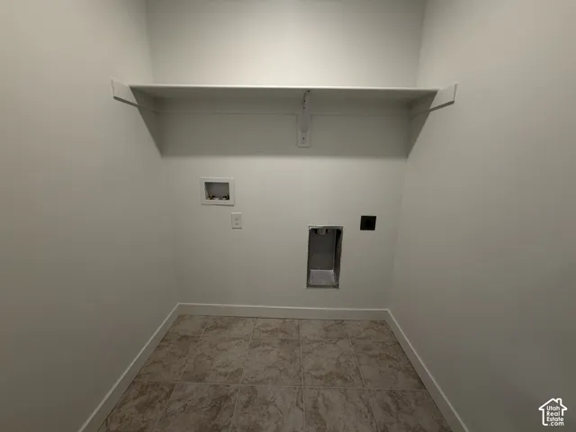 Built-in shelving, tile flooring, and utility hookups