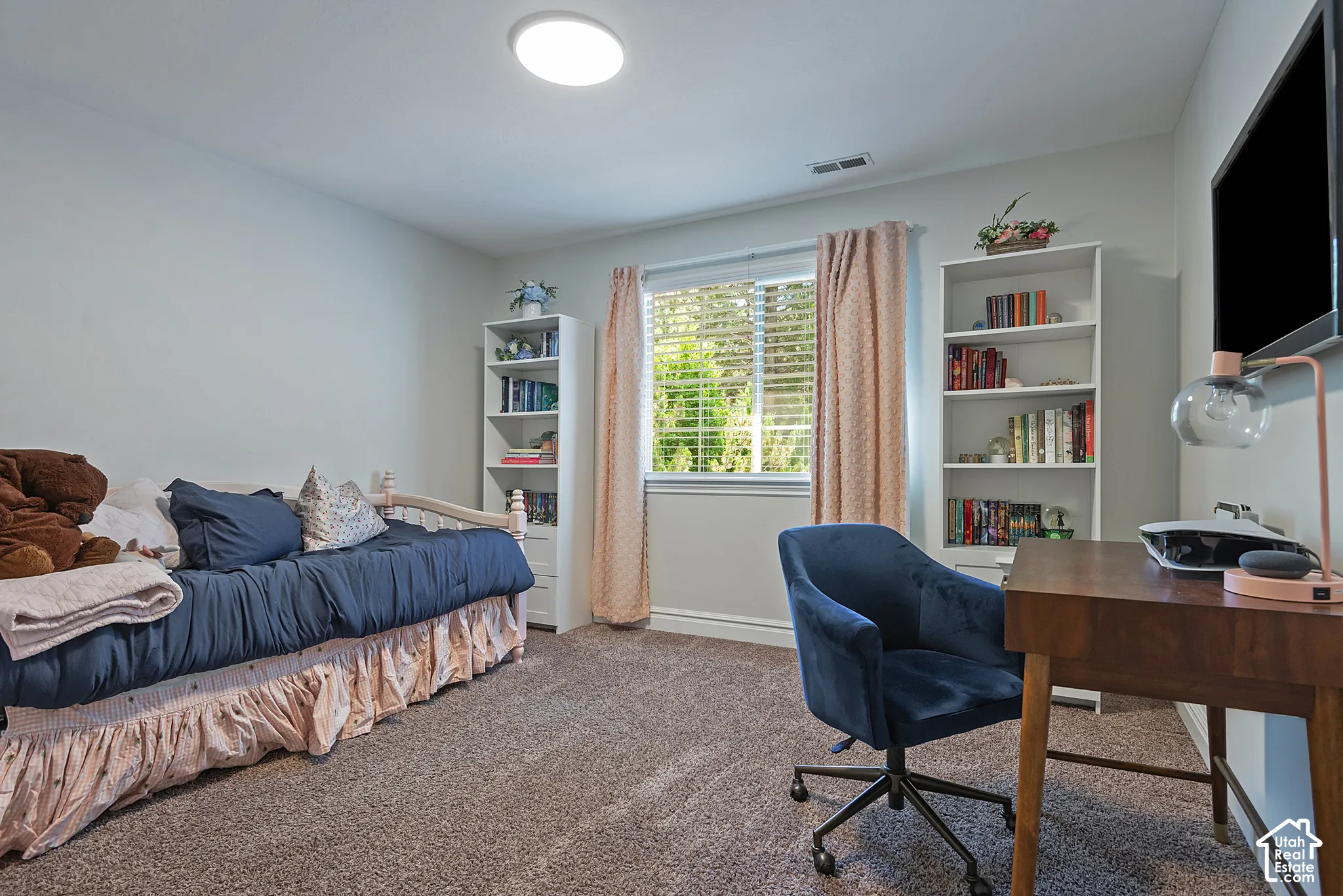 Neutral wall finishes with a large window featuring blinds