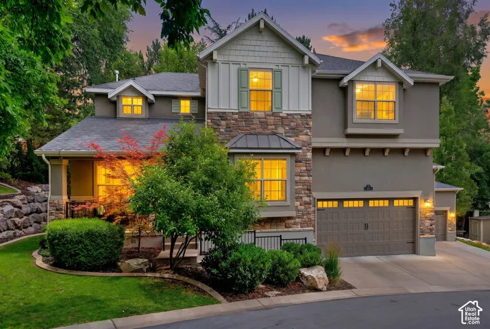 Stone veneer and stucco exterior with multiple gables
