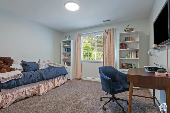 Neutral wall finishes with a large window featuring blinds
