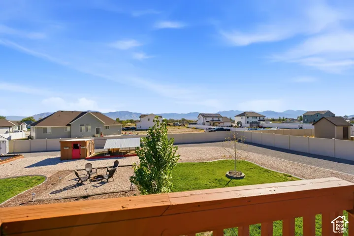 Expansive backyard featuring a large gravel area, a dedicated fire pit area, and a green lawn space