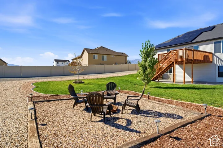 Gravel patio area with wood-finish edging and ground lighting