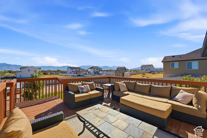 Expansive outdoor deck featuring wood-finish flooring and a full-height wood railing