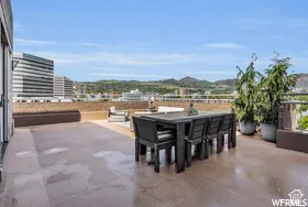 Expansive rooftop terrace featuring a hard surface floor and integrated planters