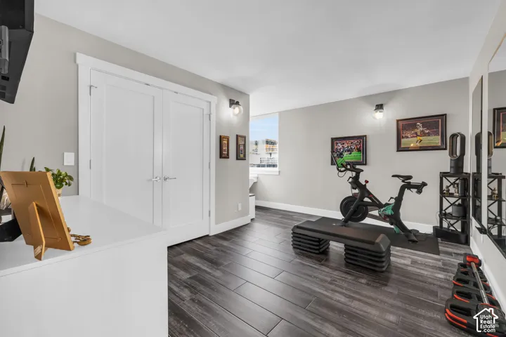 Wood-finish flooring with light gray walls, white trim, and bi-fold doors