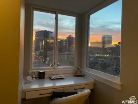 Built-in desk with dual drawers, featuring a corner window with city scenery