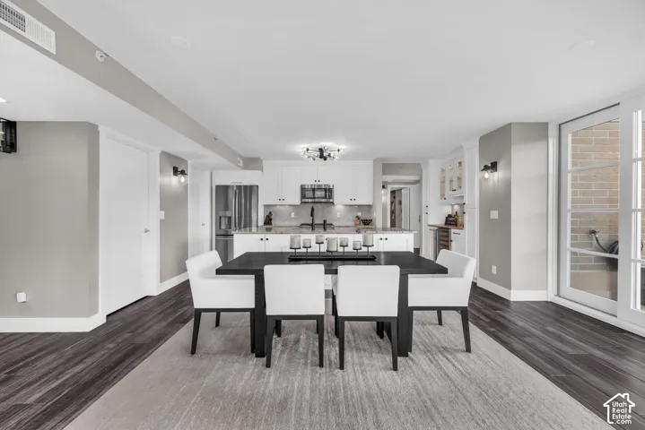 Open-concept living space with dark wood-finish flooring