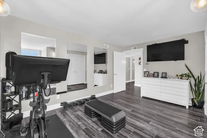 Wood-finish flooring, recessed lighting, and wall-mounted television