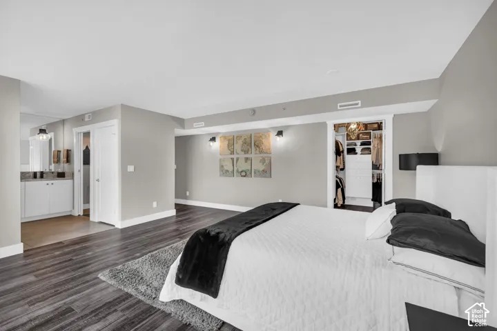 Wood-finish flooring throughout, light gray wall tones, and modern wall-mounted lighting fixtures